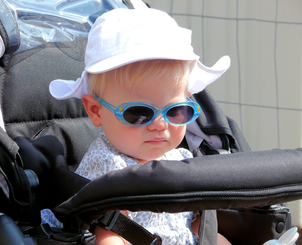 Child wearing sunglasses & hat